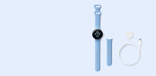 Google Pixel Watch 2 with a Bay Active Band sits beside the included smaller band size and USB-C Fast Charging Cable