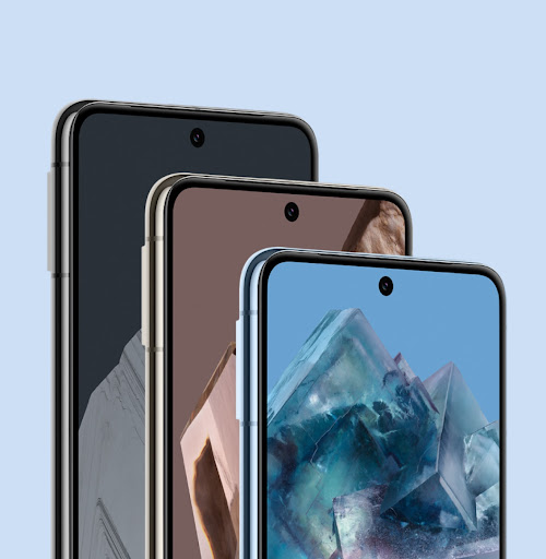 Three Pixel 8 Pros in various colours. They stand behind one another. Their home screens are on, showing off the smooth, scratch-resistant glass.