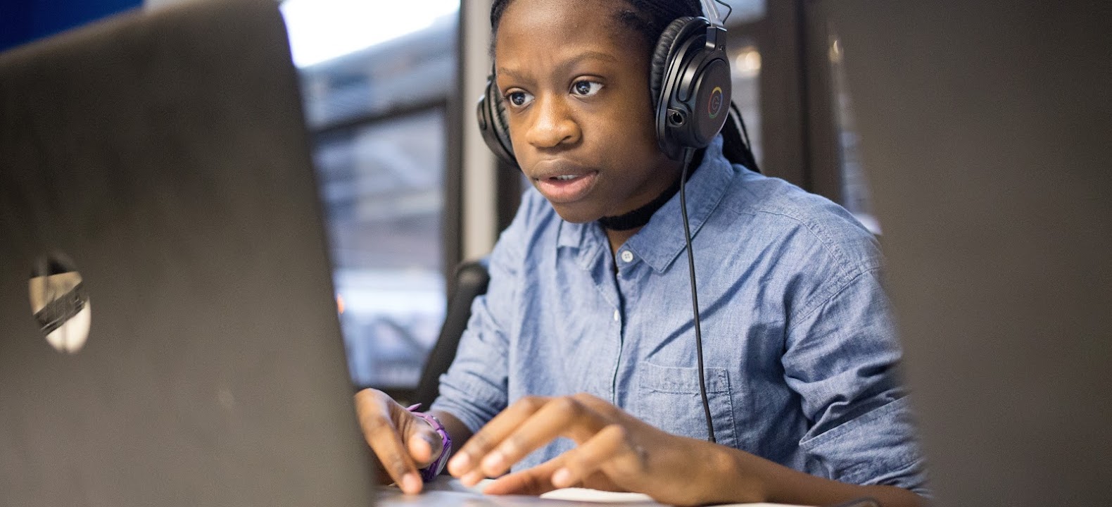 Black female student engages with technology.