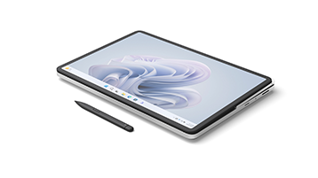 创意画布模式下的 Surface Laptop Studio 2，屏幕上显示有 Windows bloom，设备旁边放置着超薄触控笔 2。