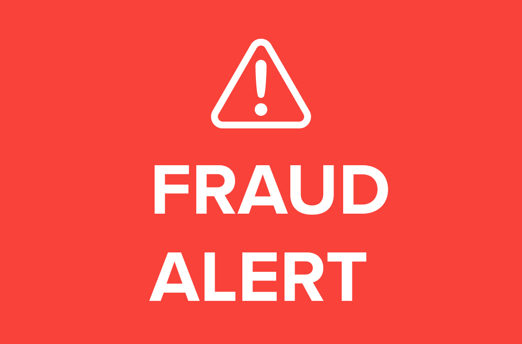 Warning symbol with fraud alert text on red background