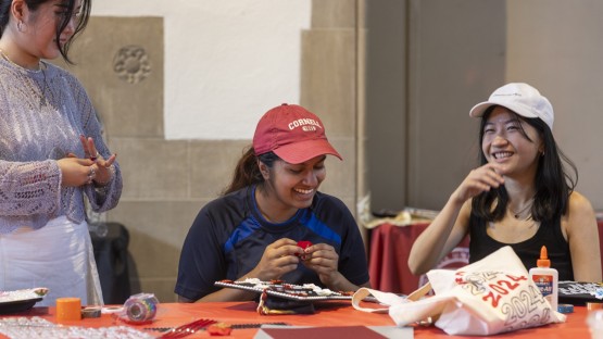 Students decorate their graduation caps during a Senior Days activity at Willard Straight Hall.