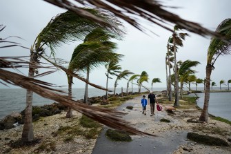Two people visiting Miami in the aftermath of a hurricane.