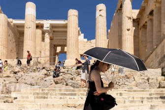 A tourist carrying an umbrella in Athens, Greece.