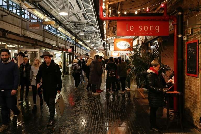 People walk through the Chelsea Market building in New York City, which was bought by Google for $2.4 billion