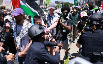 Los Angeles Police Department (LAPD) officers clash with anti-Israel protesters gathered outside the Adas Torah Orthodox Jewish synagogue in Los Angeles, June 23, 2024. (Photo by David Swanson/AFP)