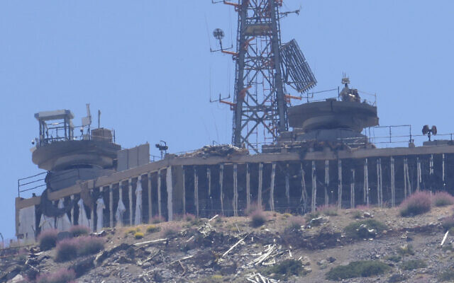A damaged Israeli military position targeted by Hezbollah terrorists is seen on the top of Mount Hermon in the Israeli-controlled Golan Heights, from Chebaa, a Lebanese town near the border with Israel, south Lebanon, June 26, 2024. (AP/Hussein Malla)