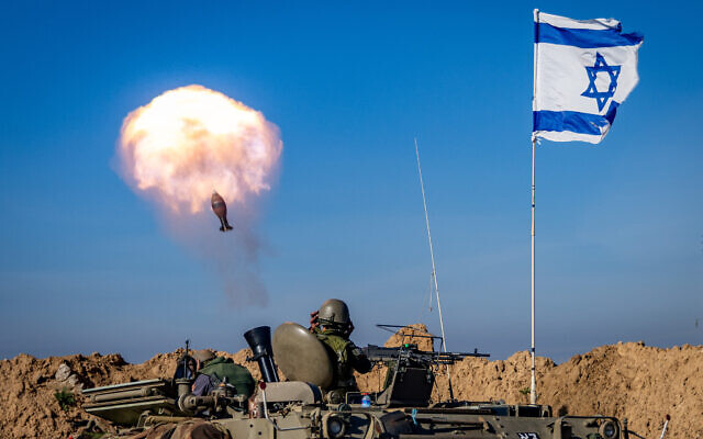 Illustrative: Israeli soldiers fire mortar shells towards targets in the Gaza Strip near the border with the Gaza Strip on February 8, 2024. (Chaim Goldberg/Flash90)