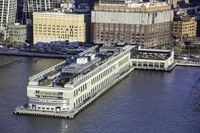 Exterior image of Pier 57 showing the long rectangular building built on top of the water.