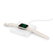 A white Apple Watch lies flat charging on the white charger.