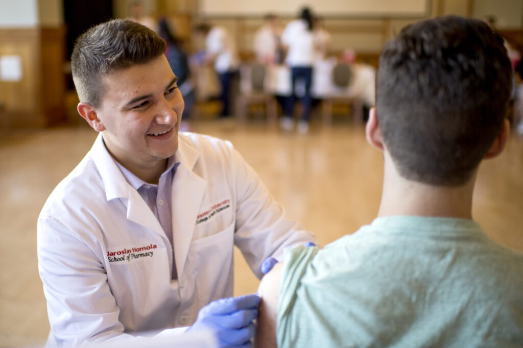 student receiving a flu shot