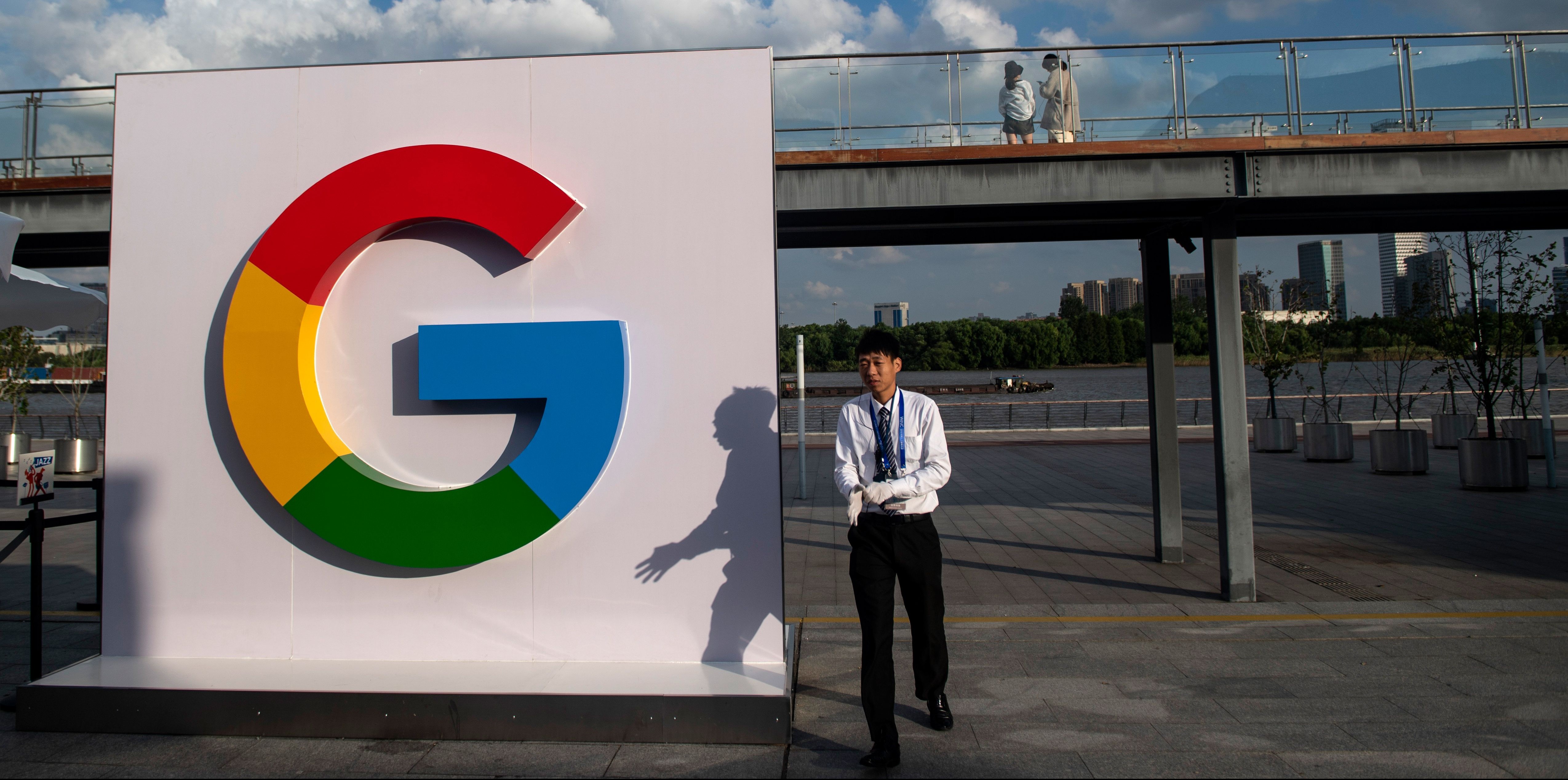 A man passes a Google sign for the World Artificial Intelligence Conference (WAIC) in Shanghai on  September 26, 2018. (Photo by Johannes EISELE / AFP)        (Photo credit should read JOHANNES EISELE/AFP/Getty Images)