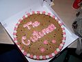 A cookie cake is a large cookie that can be decorated with icing or fondant like a cake. This is made by Mrs. Fields