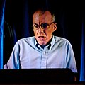 Bill McKibben, an American environmentalist and writer, attending the 2006 Stanford Singularity Summit via an HDTV telepresence system, 13 May 2006