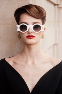 Balmain sunglasses; Courreges crepe dress; Patou earrings.