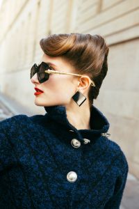 Bulgari sunglasses; Rabanne knitted tweed coat; Versace earrings.