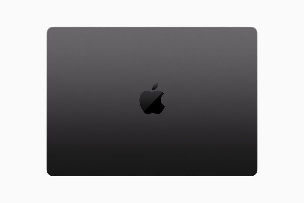 Vue du dessus d’un MacBook Pro fermé sur un fond noir.