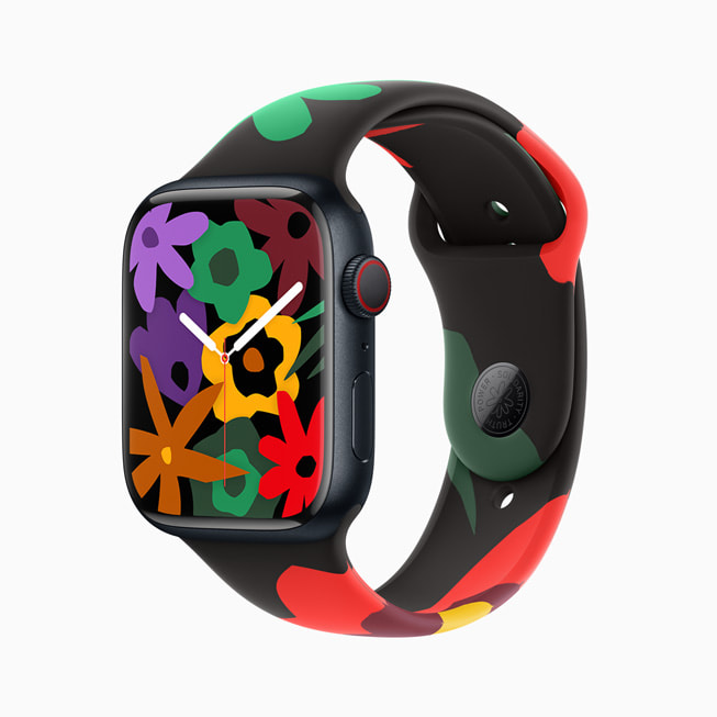 새로운 Black Unity 컬렉션 밴드 및 페이스를 보여주는 Apple Watch Series 9. 이미지 속 시계 페이스에는 무지개 빛깔의 꽃들이 무리를 이루고 있다.
