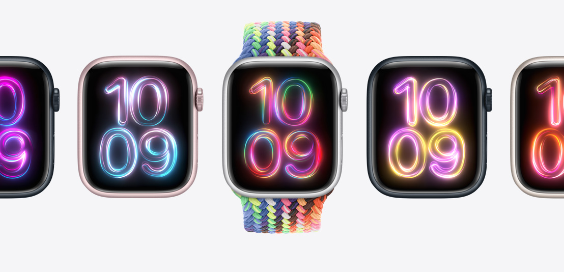Apple Watch Series 9 watches, with a new neon multi-colored Pride Edition Braided Solo Loop on the middle watch, and the Pride Radiance watch face shown in different colors on each watch.