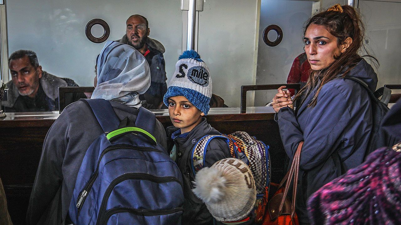 Palestinians with foreign passports leave to Egypt via the Rafah border crossing with Egypt