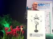 The European Data Protection Supervisor delivering a speech at CPDP conferences behind a podium and next to plants and flowers