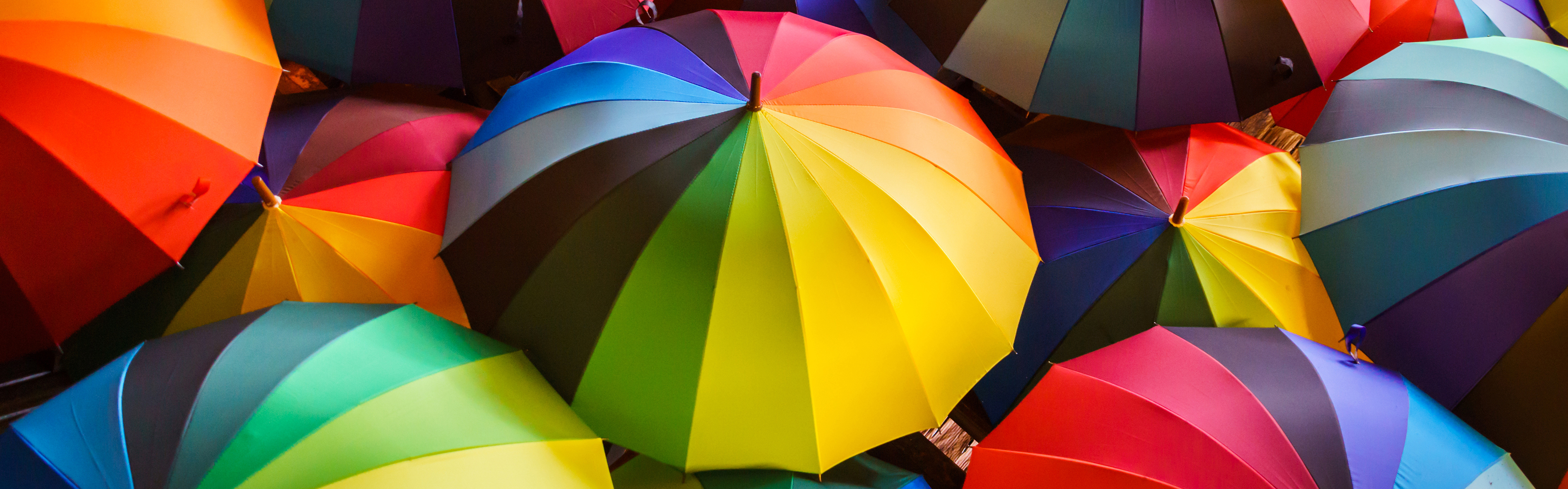 Diversity - multicoloured umbrellas grouped together