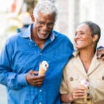 Happy couple enjoying ice cream in retirement.