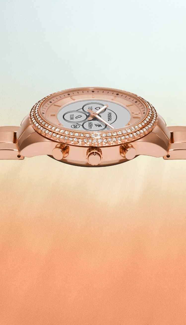 A closeup of the rose gold-tone Gen 6 Hybrid smartwatch with a dial displaying a notification to attend a party.