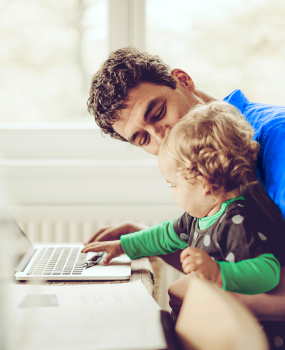 father and child working on computer
