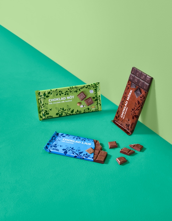 Three chocolate bars on a light and darker green background.
