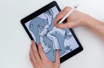 Person drawing on an old iPad