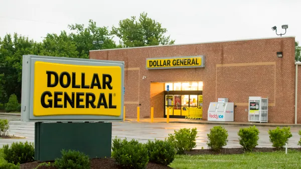 A Dollar General sign and brick storefront on a cloudy day with the company's signature black on yellow logo