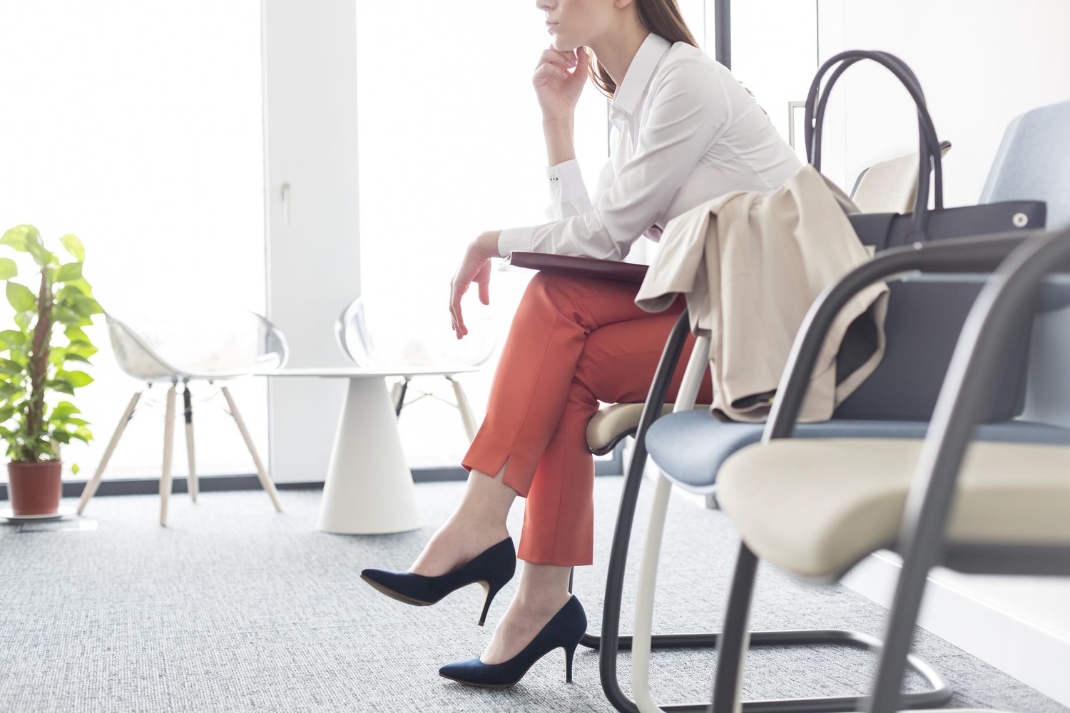 Businesswoman waiting with legs crossed in lobby
