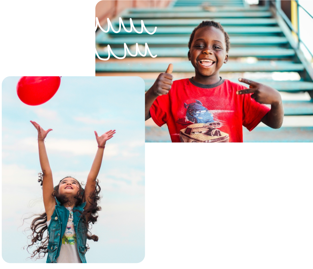 Two children one holding a colorful balloon smiling and having fun.