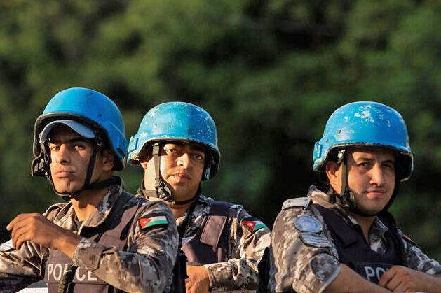 Three UN Formed Police Unit members riding on top of vehicle in Haiti.