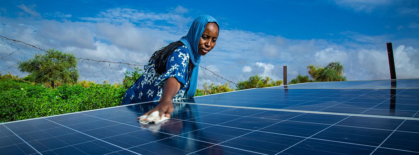 Mujer limpiando unos paneles solares