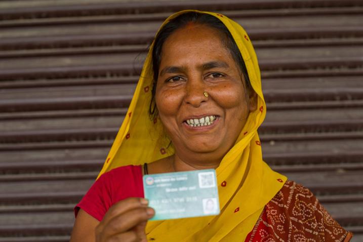 smiling woman holding up card