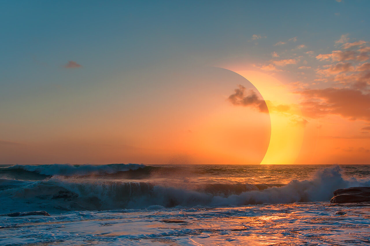 ocean waves with solar eclipse in the background