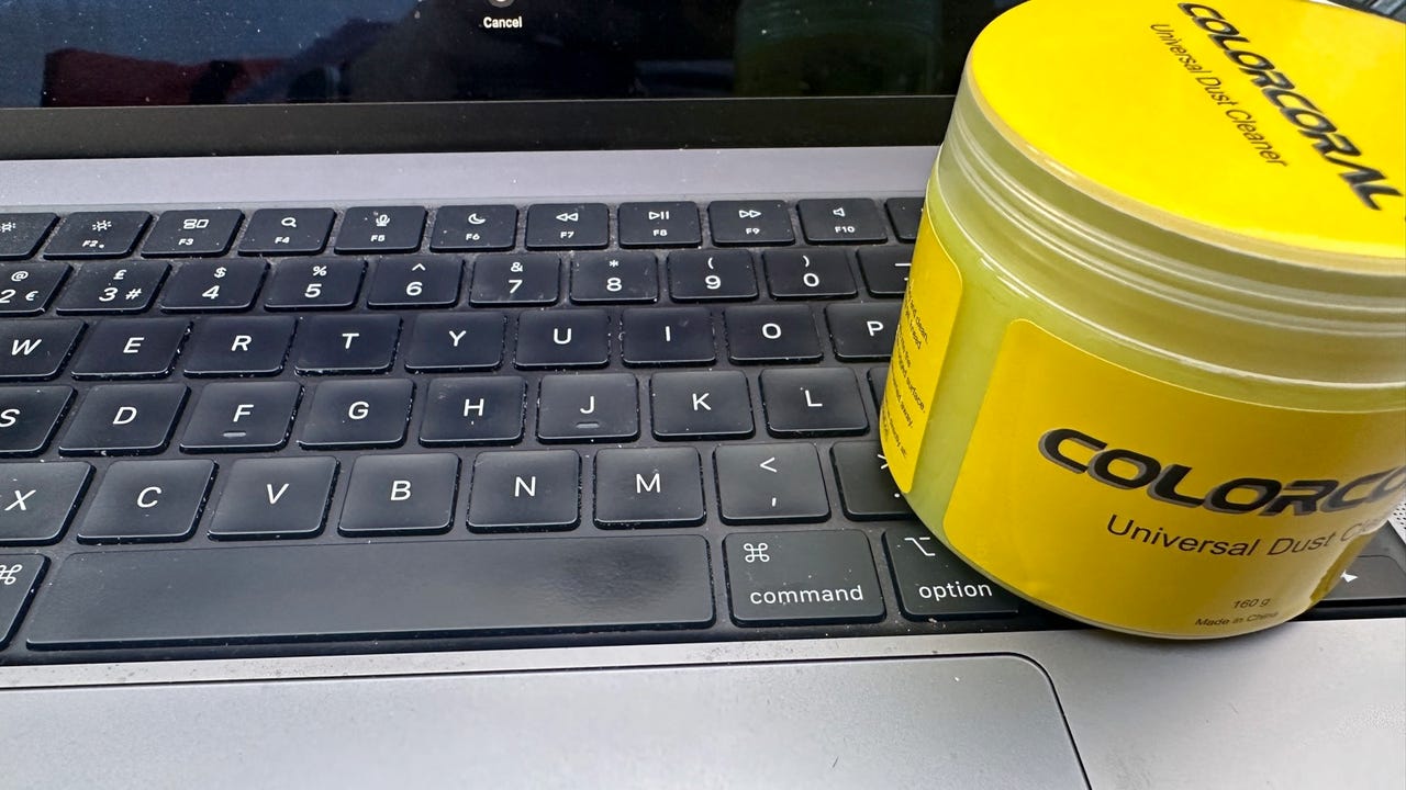 Canister of ColorCoral cleaning gel on laptop.